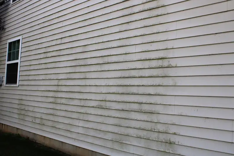 Pressure washing siding before